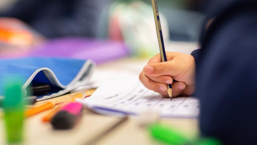 Hand of a young child writing