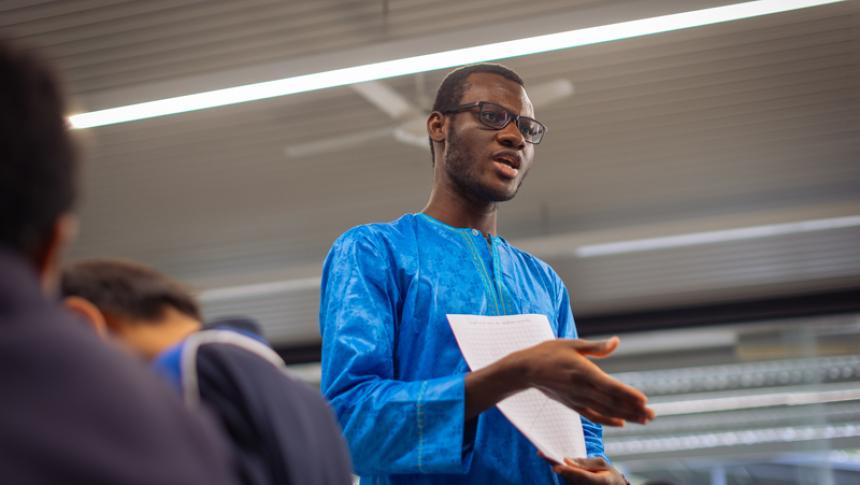A teacher talks to his students