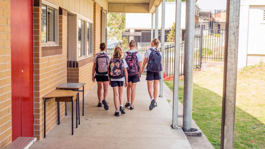 Four students leaving a classroom 