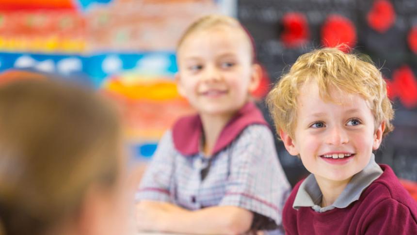 Two children look at their teacher